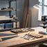Beginner woodworking workshop setup with a sturdy workbench, neatly arranged hand tools and a compact power tool, bright task lighting, and organized space for safe projects.