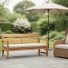 Outdoor patio furniture set with a teak bench, aluminum side table, and wicker lounge chair with neutral cushions in soft natural daylight.